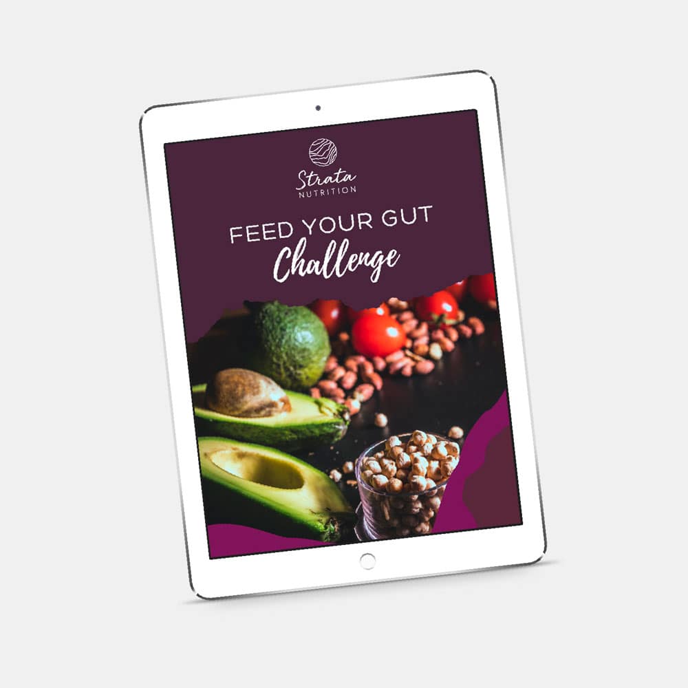 iPad showing the cover of a workbook for Strata Nutrition, titled Feed Your Gut Challenge featuring Strata's dietitian branding