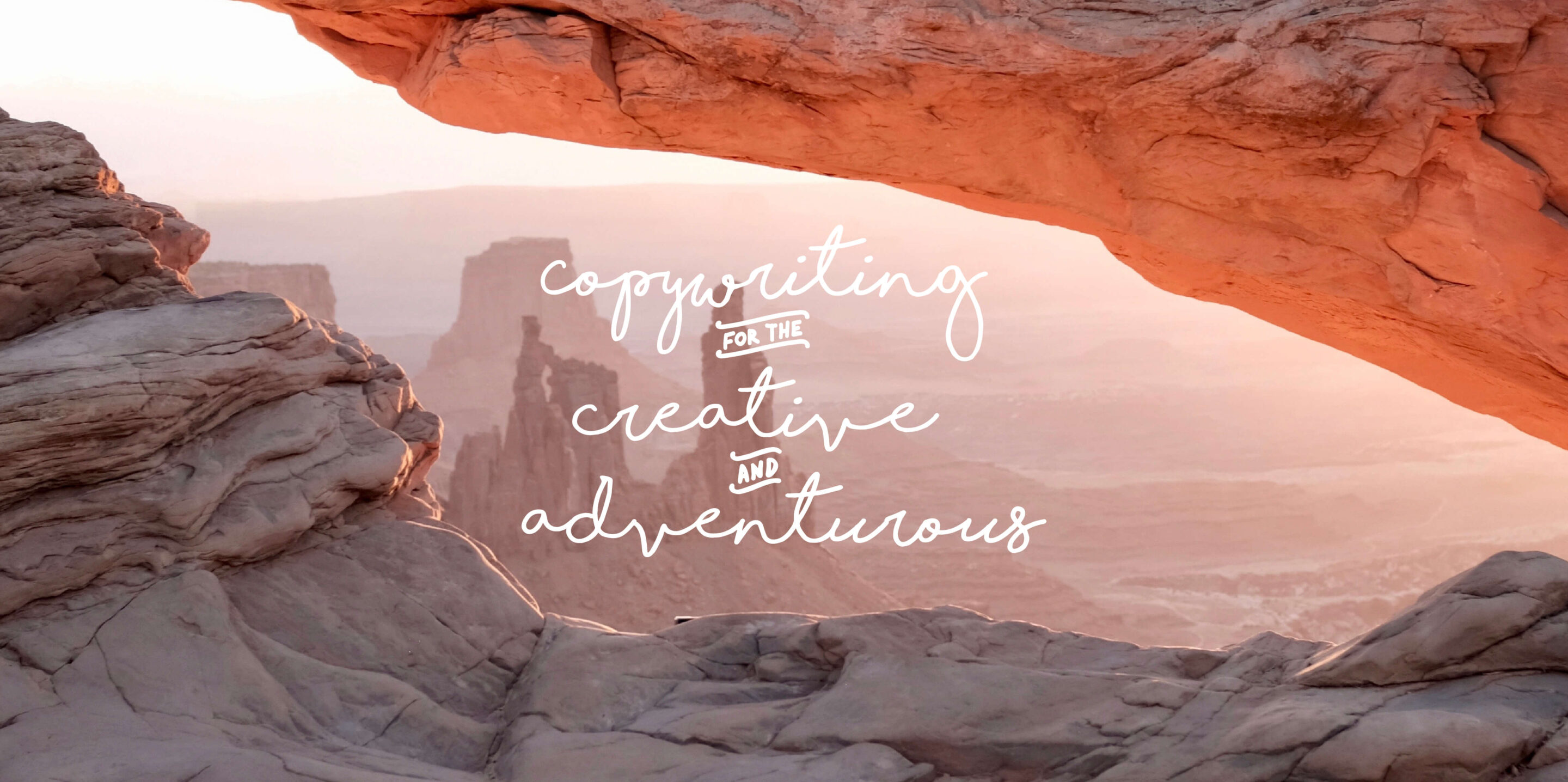 Cursive script reading copywriting for the creative and adventurous overlaid on a photograph of desert rock